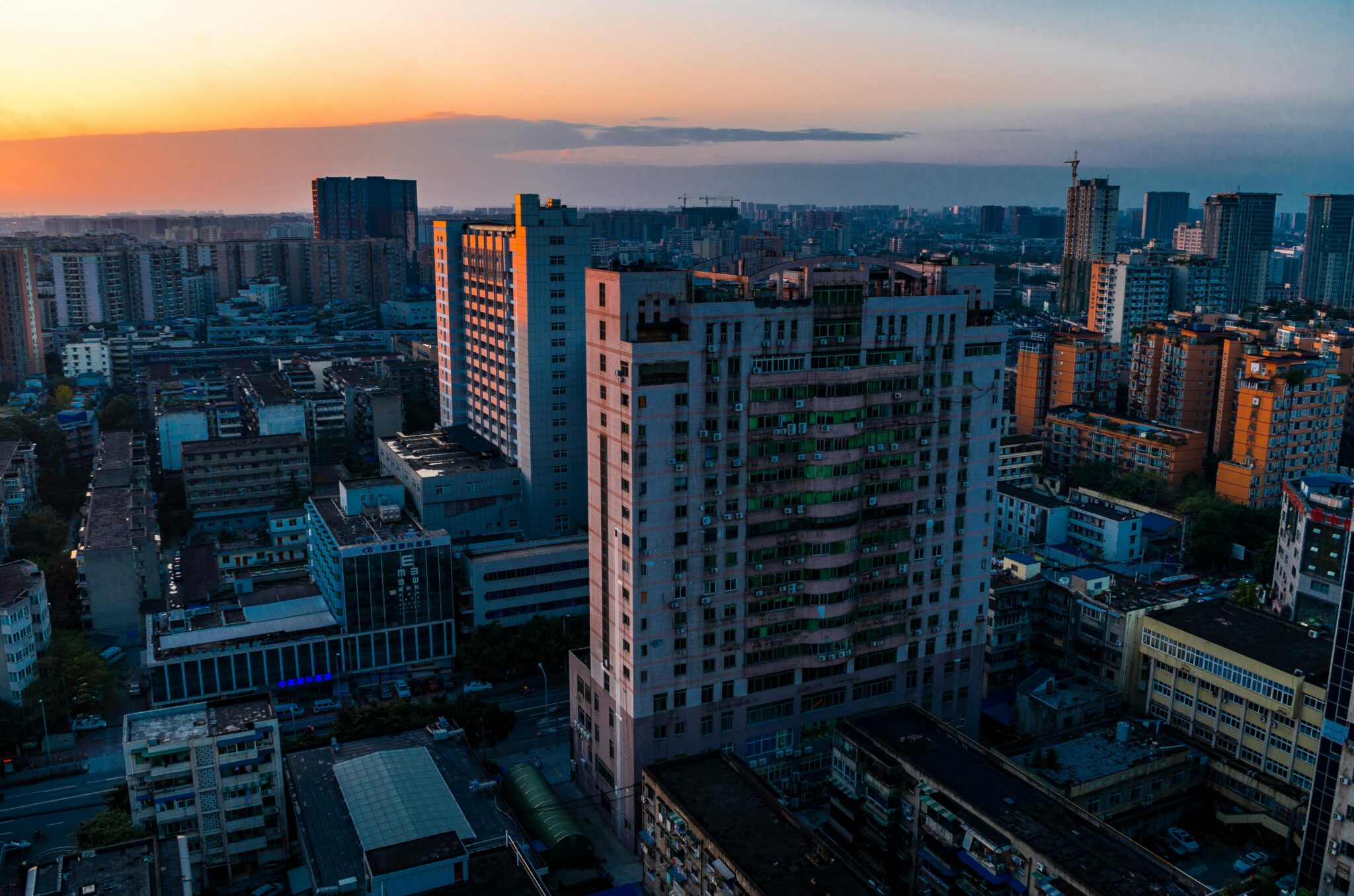Twilight view of Chengdu cityscape showcasing towering skyscrapers and urban architecture during sunset.